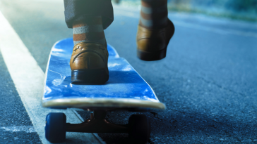 person in suit on skateboard