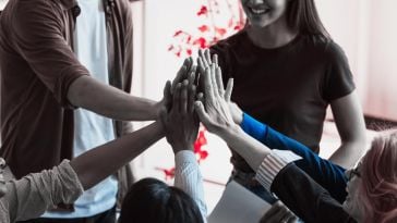 a photo of a group of people high-fiving