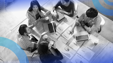 Business Analysis and Reporting group of people meeting and looking over data