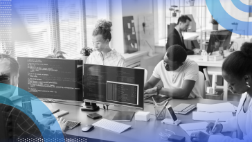 Data wrangling image of an open concept work space with several people sitting in front of desktop computers and focused on working.