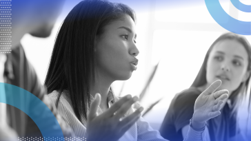 intercultural competence close-up image of a woman of color in the middle of speaking and gesturing with her hands