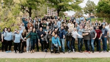 Encampers gather for.a team photo outside