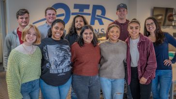 A group of people in two rows pose for a photo