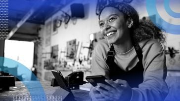 An entrepreneur looking happy in her workshop.