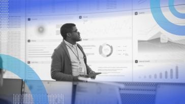 A young, Black product manager presents a screen full of data and analytics